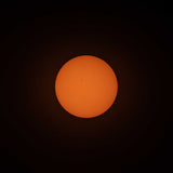 A photo of the sun, taken with ES-FLAR80640CF-iEXOS-100, showing the orange-colored sun with sunspots scattered across the visible surface of the sun